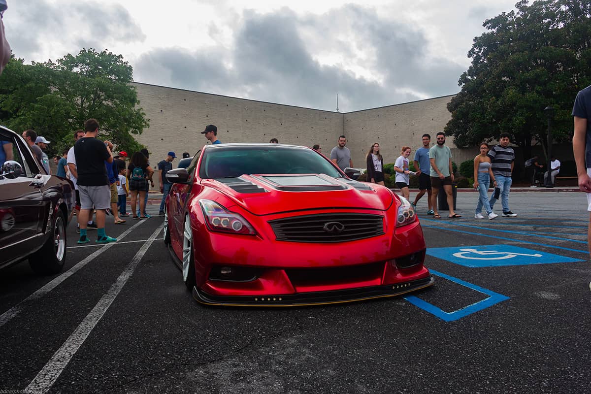 Modified red Infiniti G37 with custom headlights, hood and front bumper.