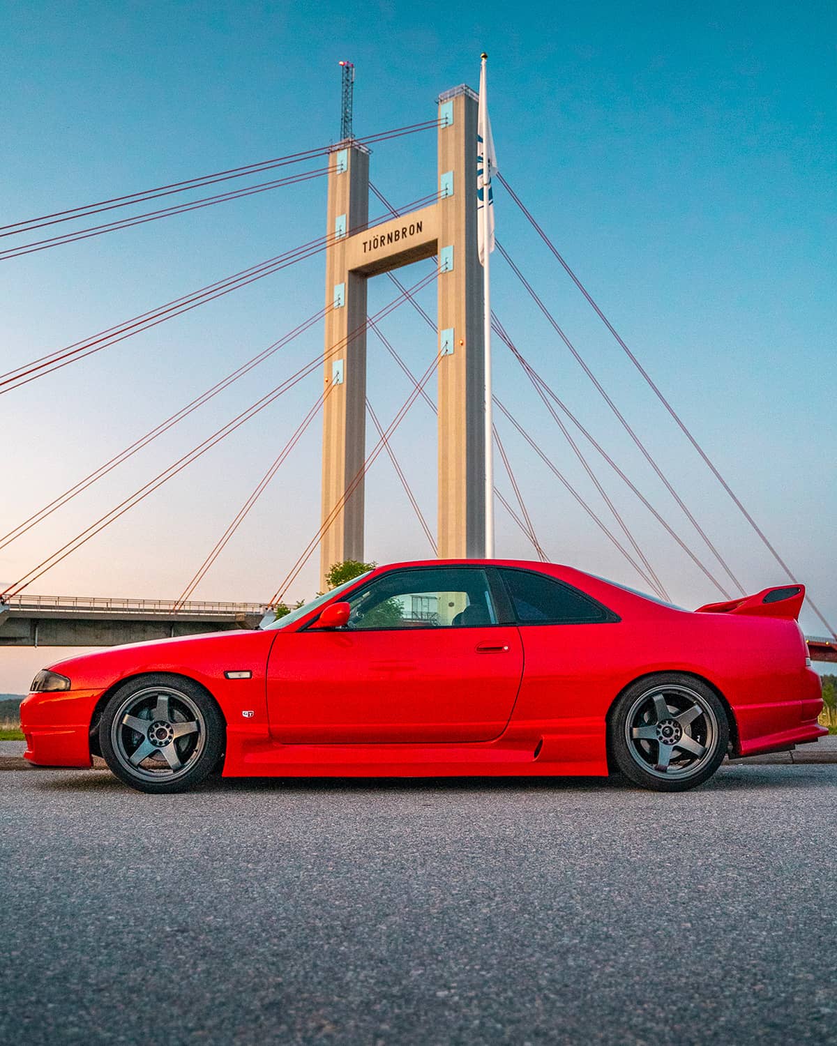 Red Nissan GT-R R33 side view on Work GT5 custom rims